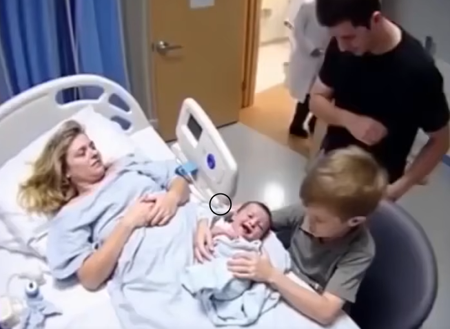 When his brother held him for the first time, the baby, thought to be stillborn, suddenly let out a strong, startling cry
